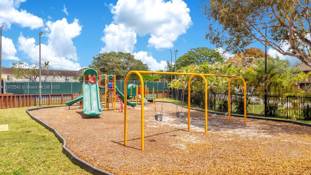 6604 Southwest 114th Place, Unit F72 Miami, FL 33173 - Photo 22 of 25 a view of a park with swings