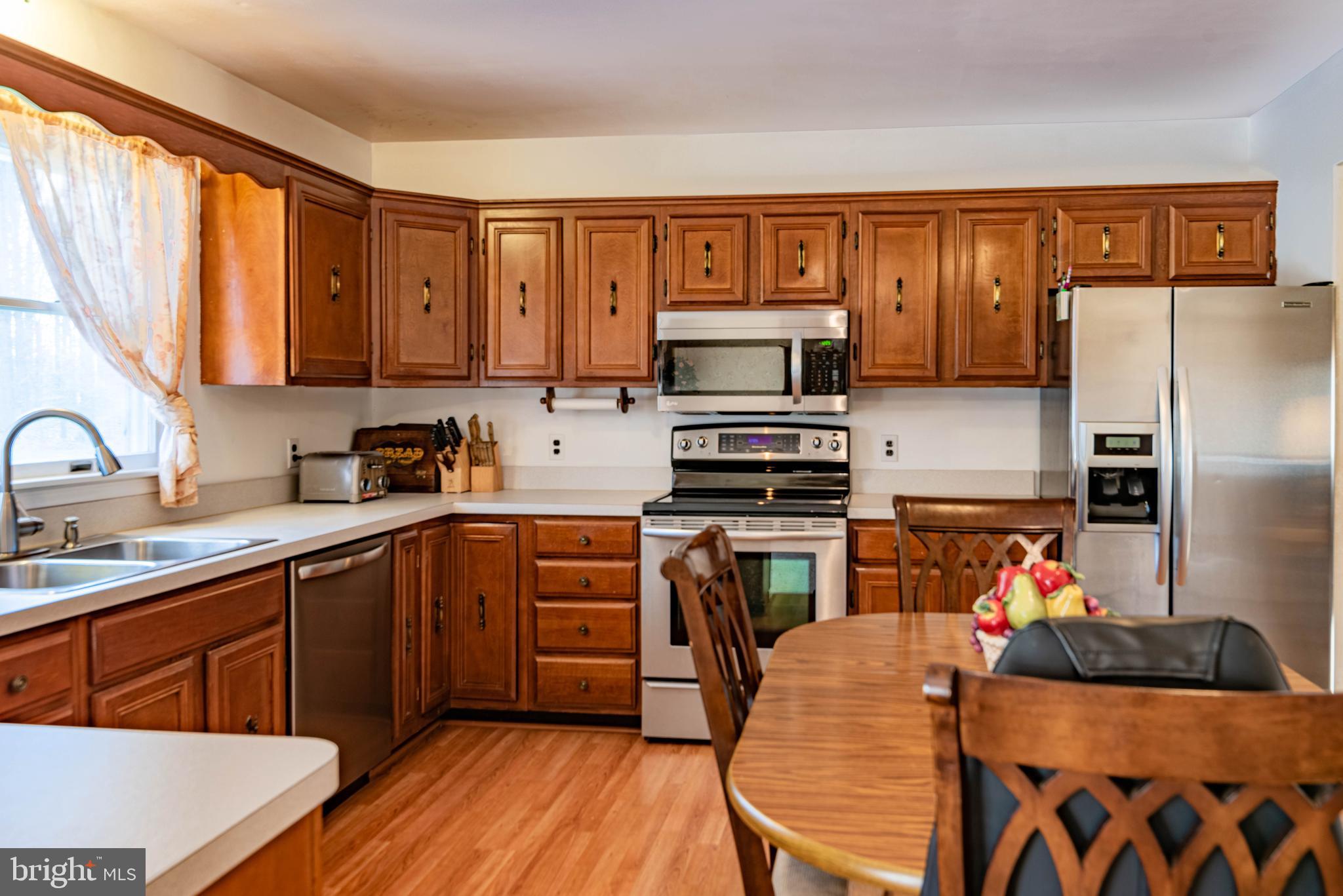 9619 Boyds Turn Road Owings, MD 20736 - Photo 6 of 69 a kitchen with stainless steel appliances granite countertop a refrigerator sink and stove