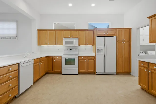 a spacious bathroom with a granite countertop sink and a mirror
