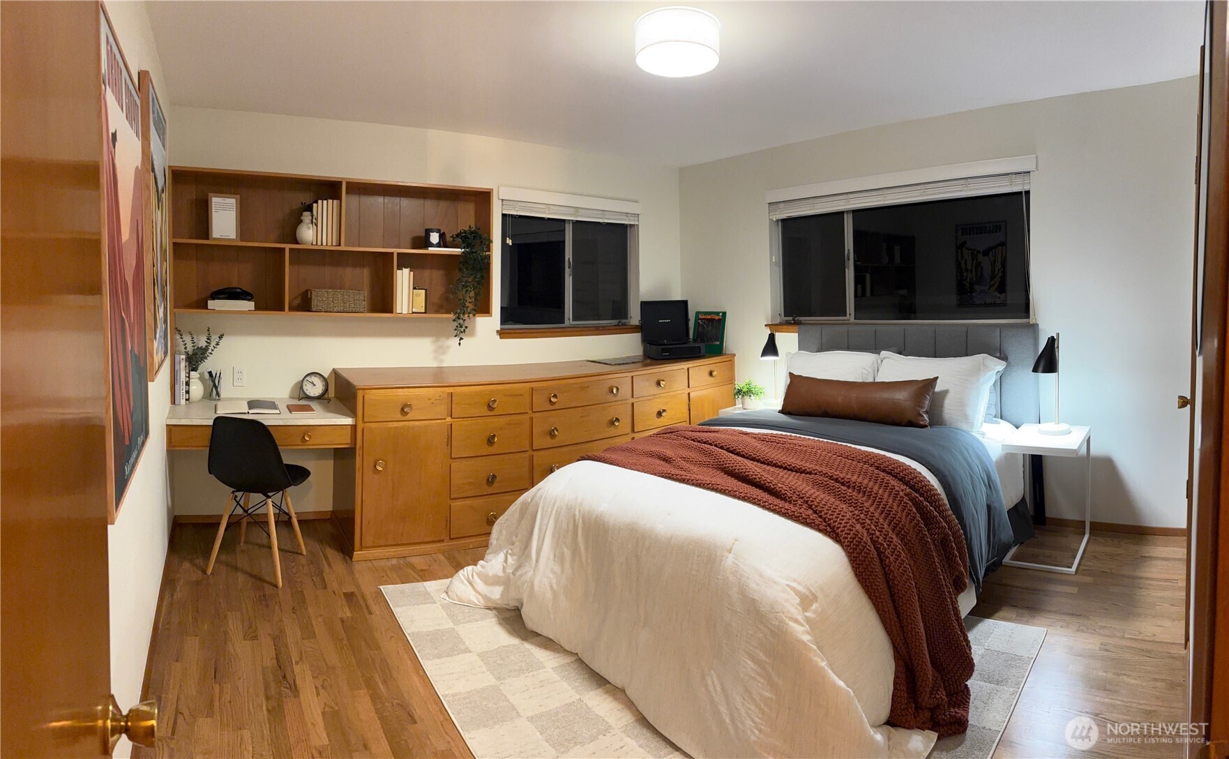 3209 61st Avenue Southwest Seattle, WA 98116 - Photo 12 of 32 a spacious bedroom with a bed and a table in it