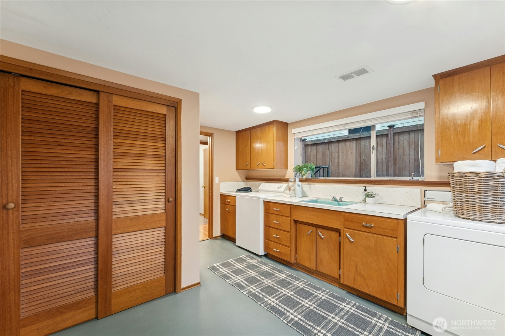 3209 61st Avenue Southwest Seattle, WA 98116 - Photo 19 of 32 a kitchen with a sink stove and cabinets