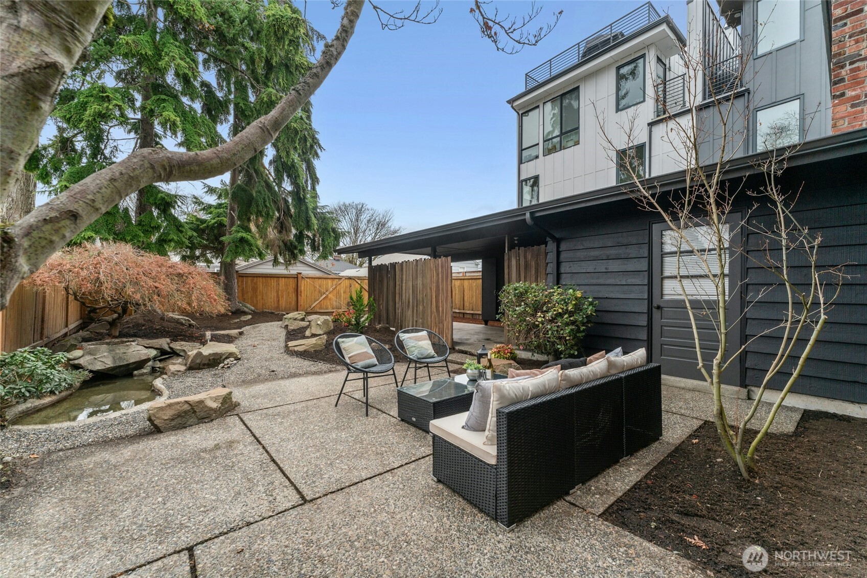 3209 61st Avenue Southwest Seattle, WA 98116 - Photo 20 of 32 a view of a patio with couches table and chairs and potted plants
