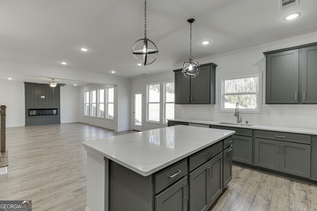1003 Lakeview Drive Commerce, GA 30529 - Photo 12 of 48 a kitchen with center island a sink stainless steel appliances and cabinets