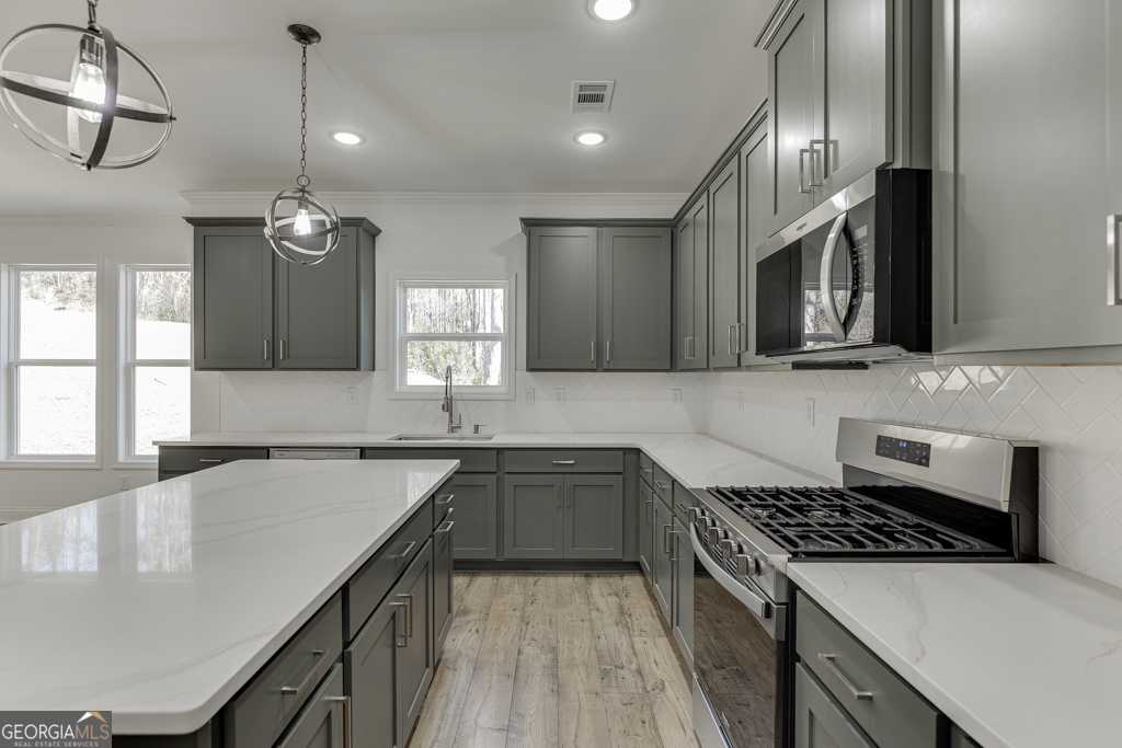 1003 Lakeview Drive Commerce, GA 30529 - Photo 13 of 48 a kitchen with stainless steel appliances granite countertop a sink stove and cabinets