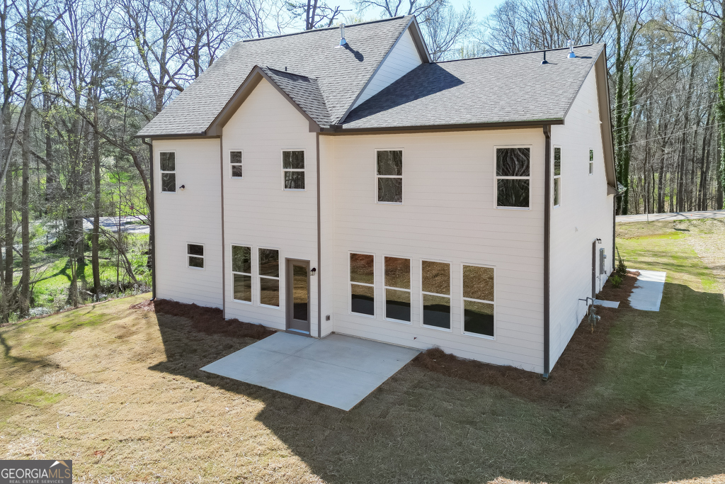 1003 Lakeview Drive Commerce, GA 30529 - Photo 42 of 48 a view of a white house with large windows and a yard with plants