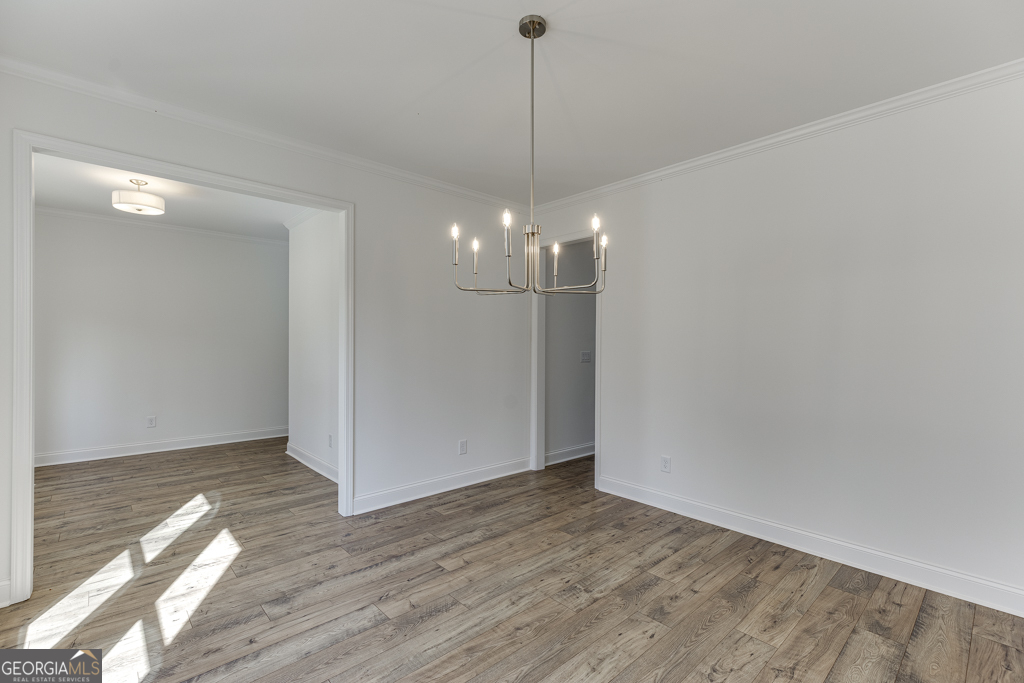 1003 Lakeview Drive Commerce, GA 30529 - Photo 6 of 48 a view of a room with wooden floor and chandelier