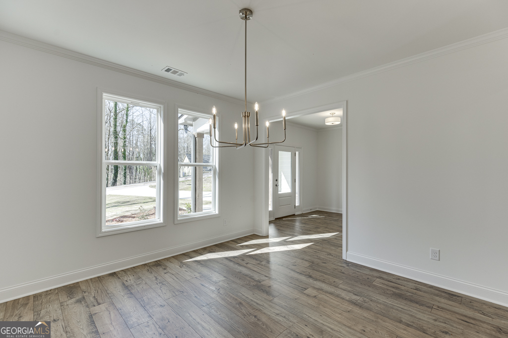 1003 Lakeview Drive Commerce, GA 30529 - Photo 7 of 48 a view of an empty room with wooden floor and a window