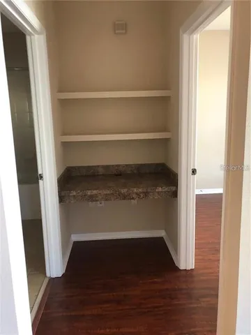 a bathroom with a granite countertop sink toilet mirror and shower