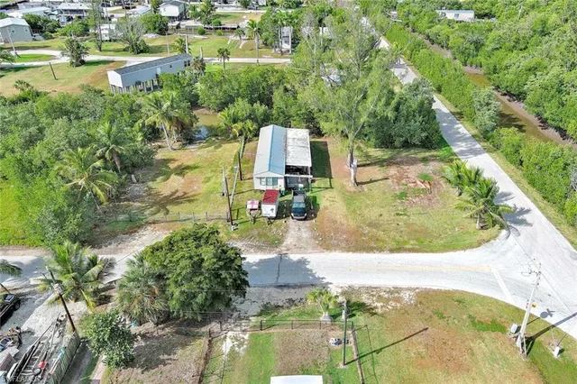 an aerial view of residential houses with outdoor space and swimming pool