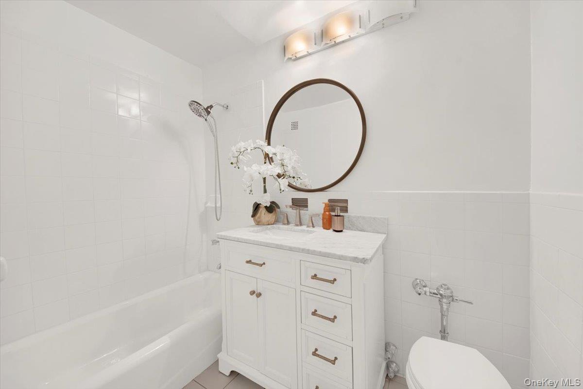 1 Balint Drive, Unit 366 Yonkers, NY 10710 - Photo 15 of 31 a bathroom with a sink a toilet and a mirror