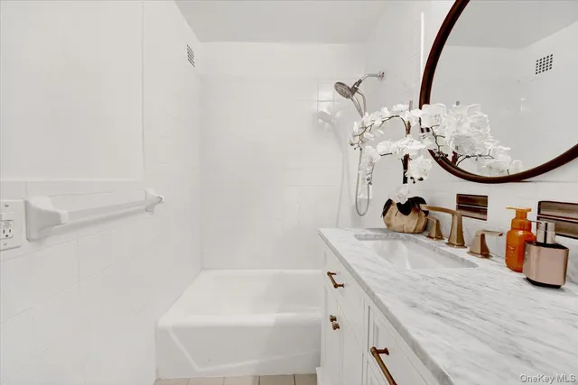 a bathroom with a sink a mirror and a bathtub