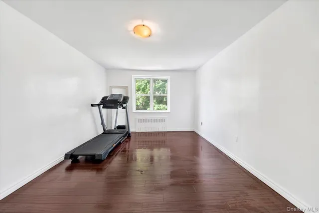 a view of room with a window and wooden floor