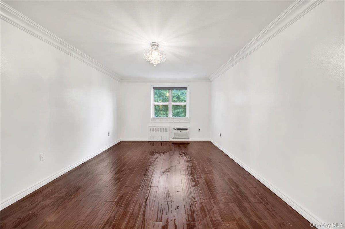 1 Balint Drive, Unit 366 Yonkers, NY 10710 - Photo 22 of 31 an empty room with wooden floor and windows