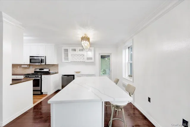 a kitchen with stainless steel appliances a sink a stove and a refrigerator