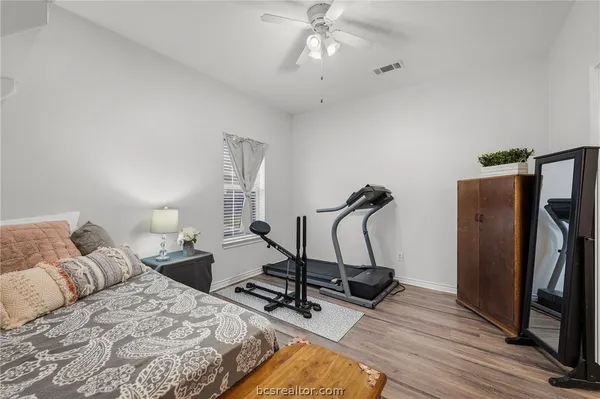 a bedroom with double bed and a chandelier