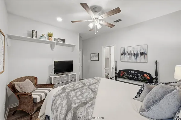 a bedroom with furniture and a flat screen tv