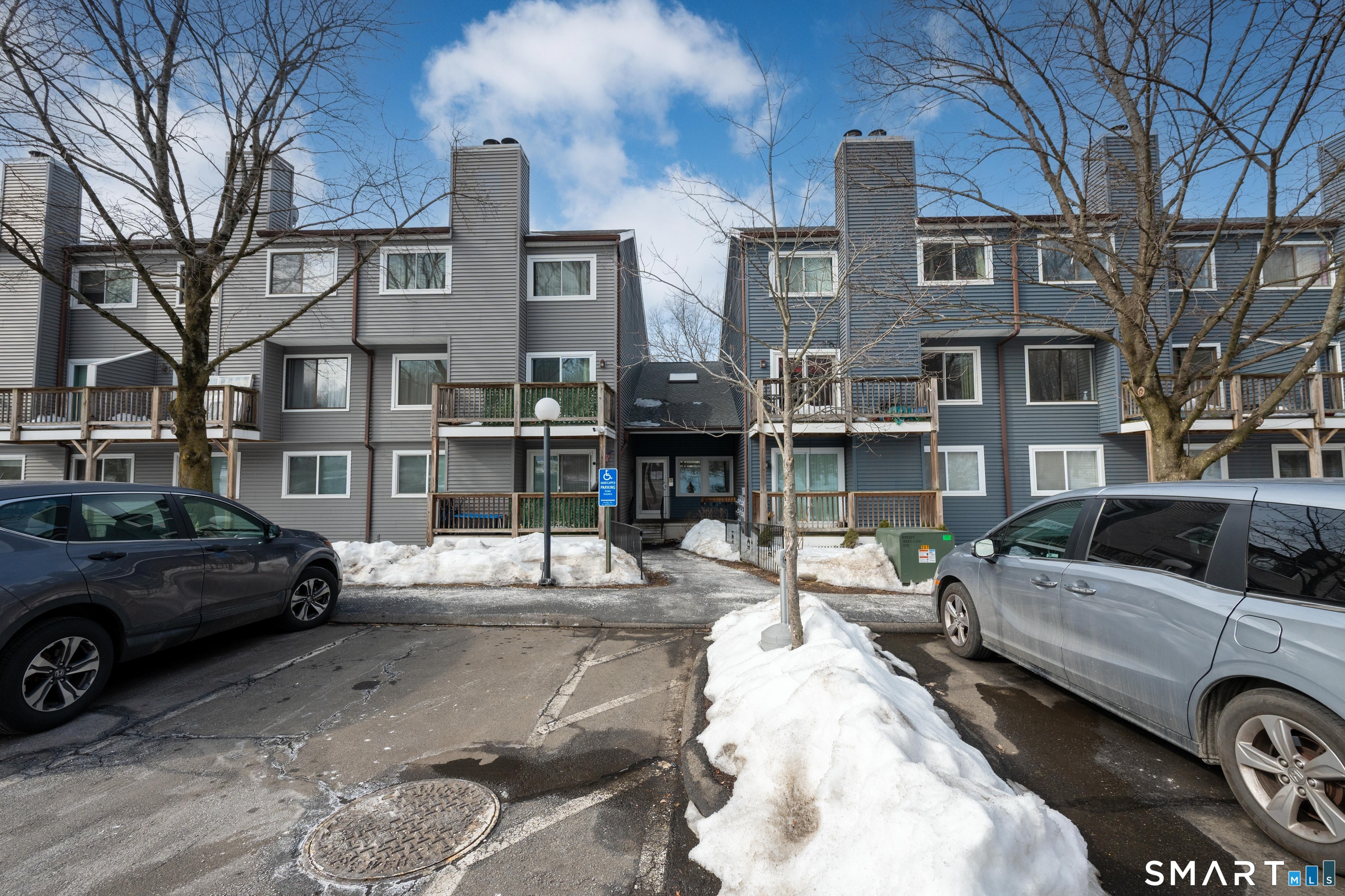 14 Newtown Road, Unit A5 Danbury, CT 06810 - Photo 1 of 27 a view of a cars park in front of a building