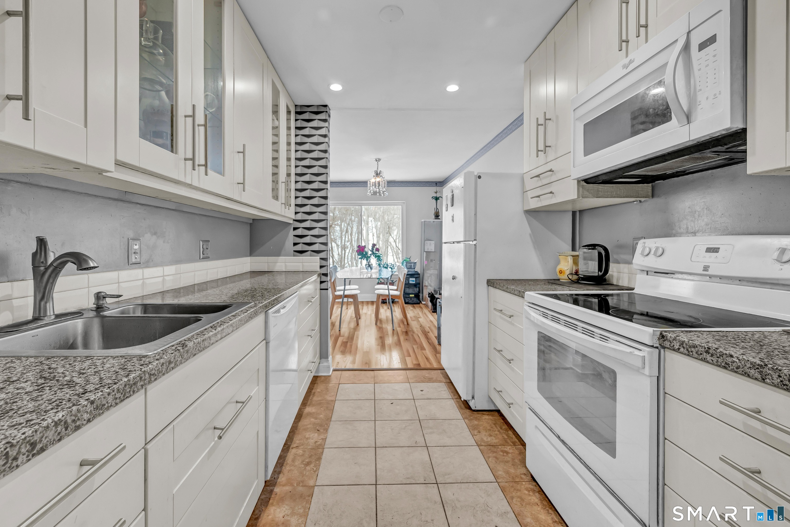 14 Newtown Road, Unit A5 Danbury, CT 06810 - Photo 13 of 27 a kitchen with granite countertop a sink and cabinets