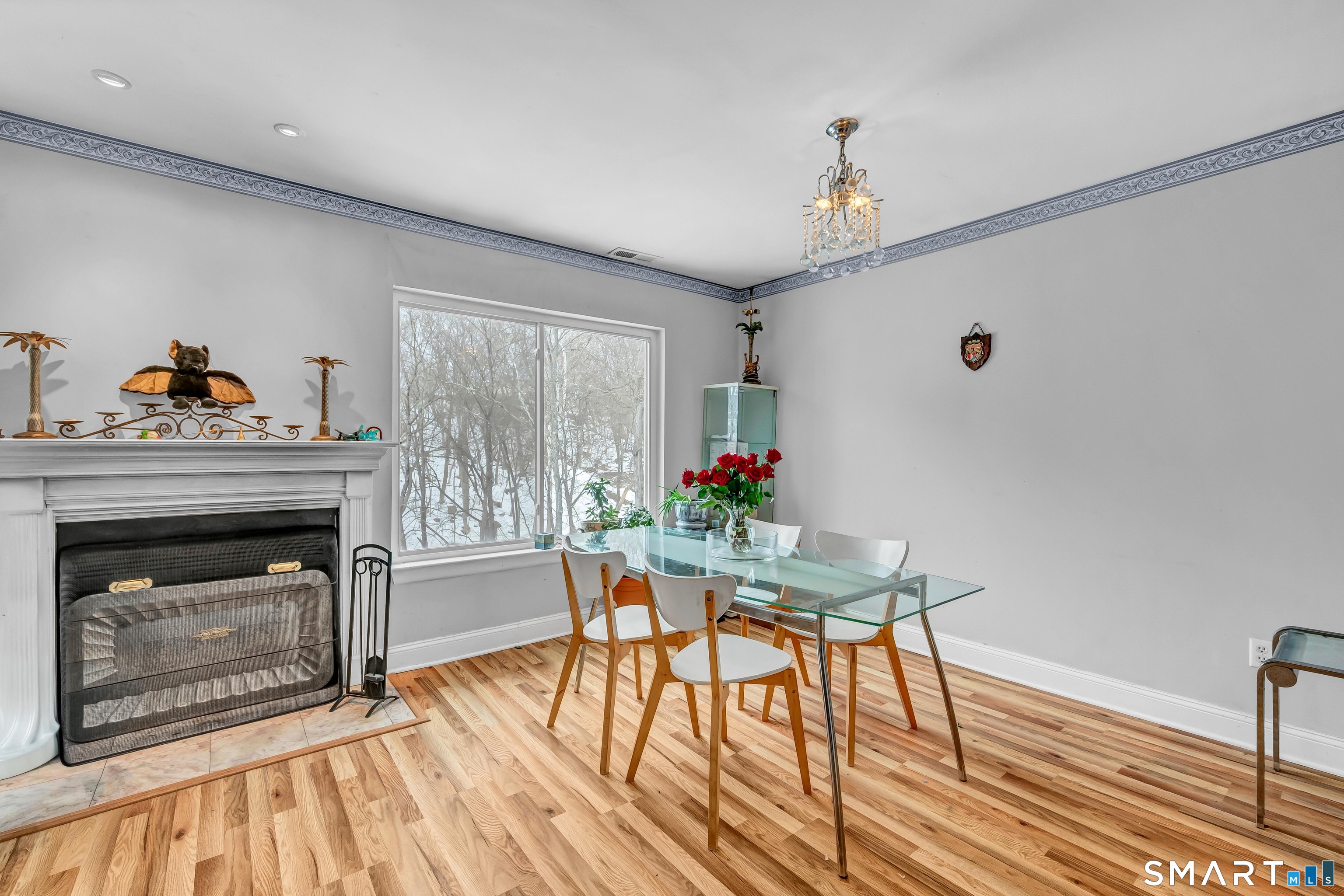 14 Newtown Road, Unit A5 Danbury, CT 06810 - Photo 4 of 27 a dining room with furniture a fireplace and wooden floor