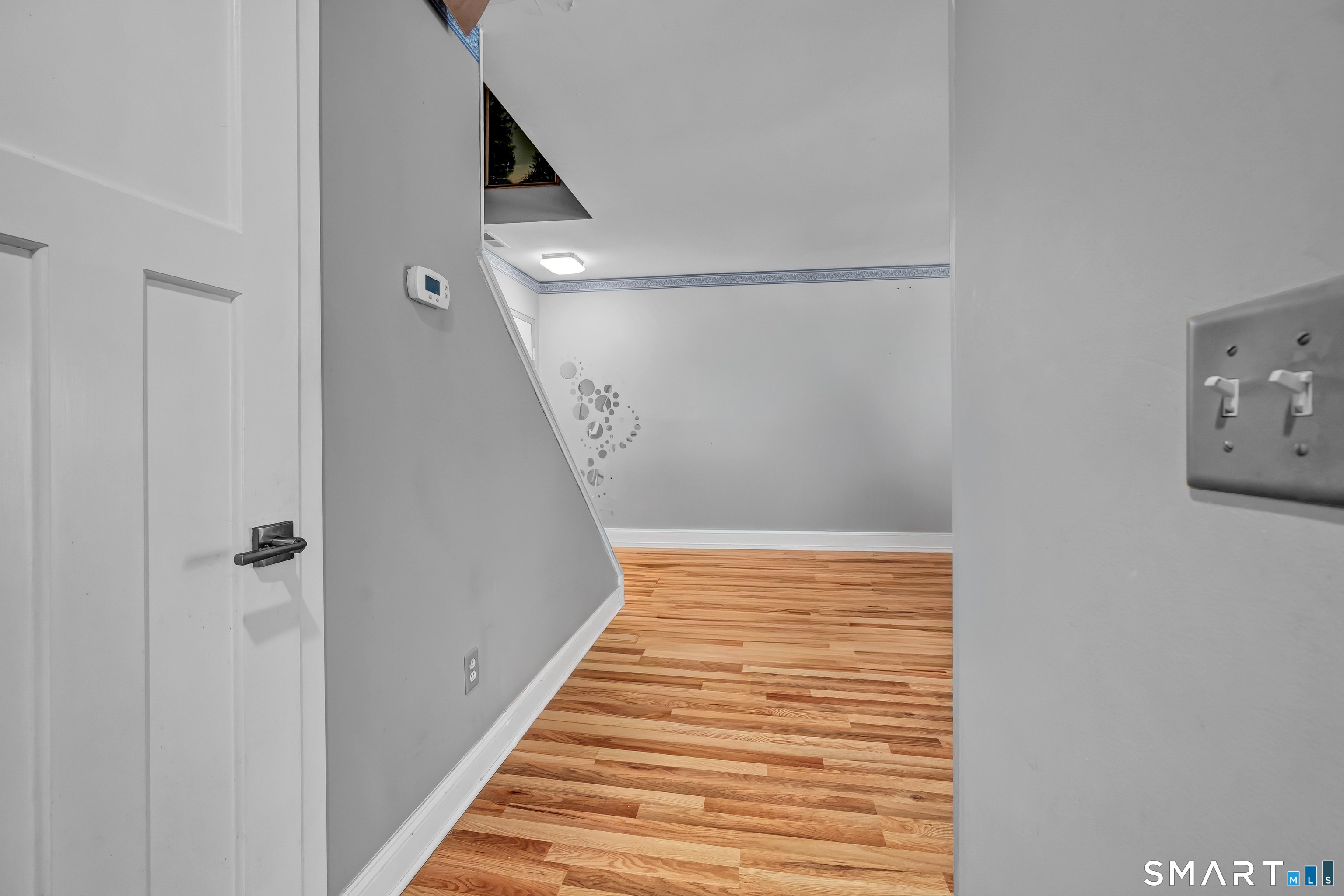 14 Newtown Road, Unit A5 Danbury, CT 06810 - Photo 9 of 27 a view of a hallway with wooden floor and entryway