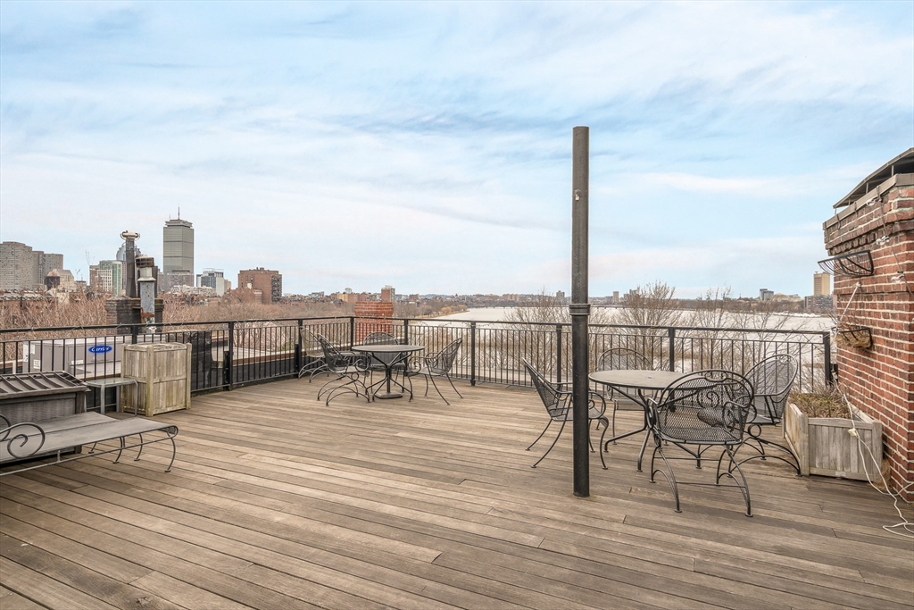 112 Pinckney Street, Unit 11 Boston, MA 02114 - Photo 14 of 16 a view of a terrace with wooden benches