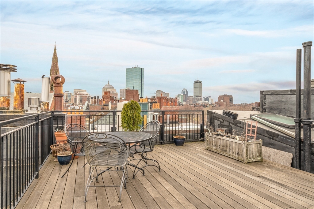 112 Pinckney Street, Unit 11 Boston, MA 02114 - Photo 15 of 16 a view of a terrace with wooden benches