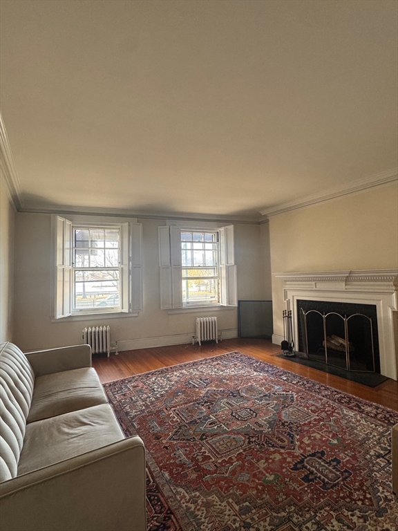 112 Pinckney Street, Unit 11 Boston, MA 02114 - Photo 4 of 16 a living room with furniture window and fireplace