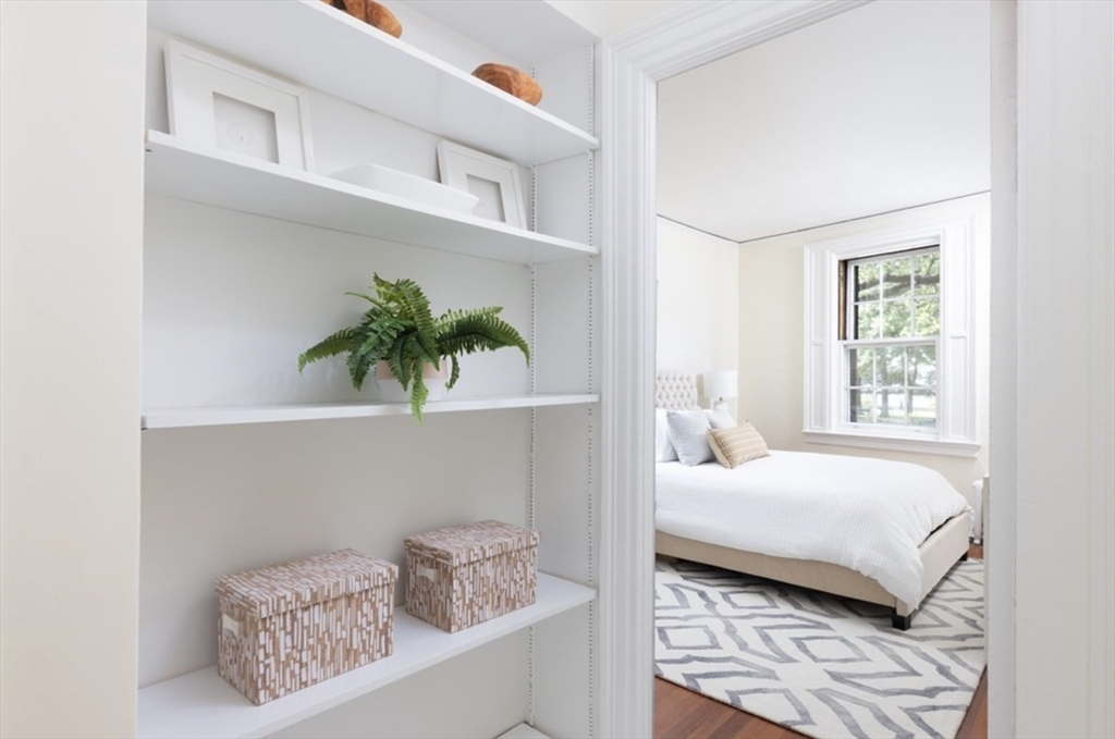 112 Pinckney Street, Unit 11 Boston, MA 02114 - Photo 9 of 16 a bedroom with a bed a potted plant and a window