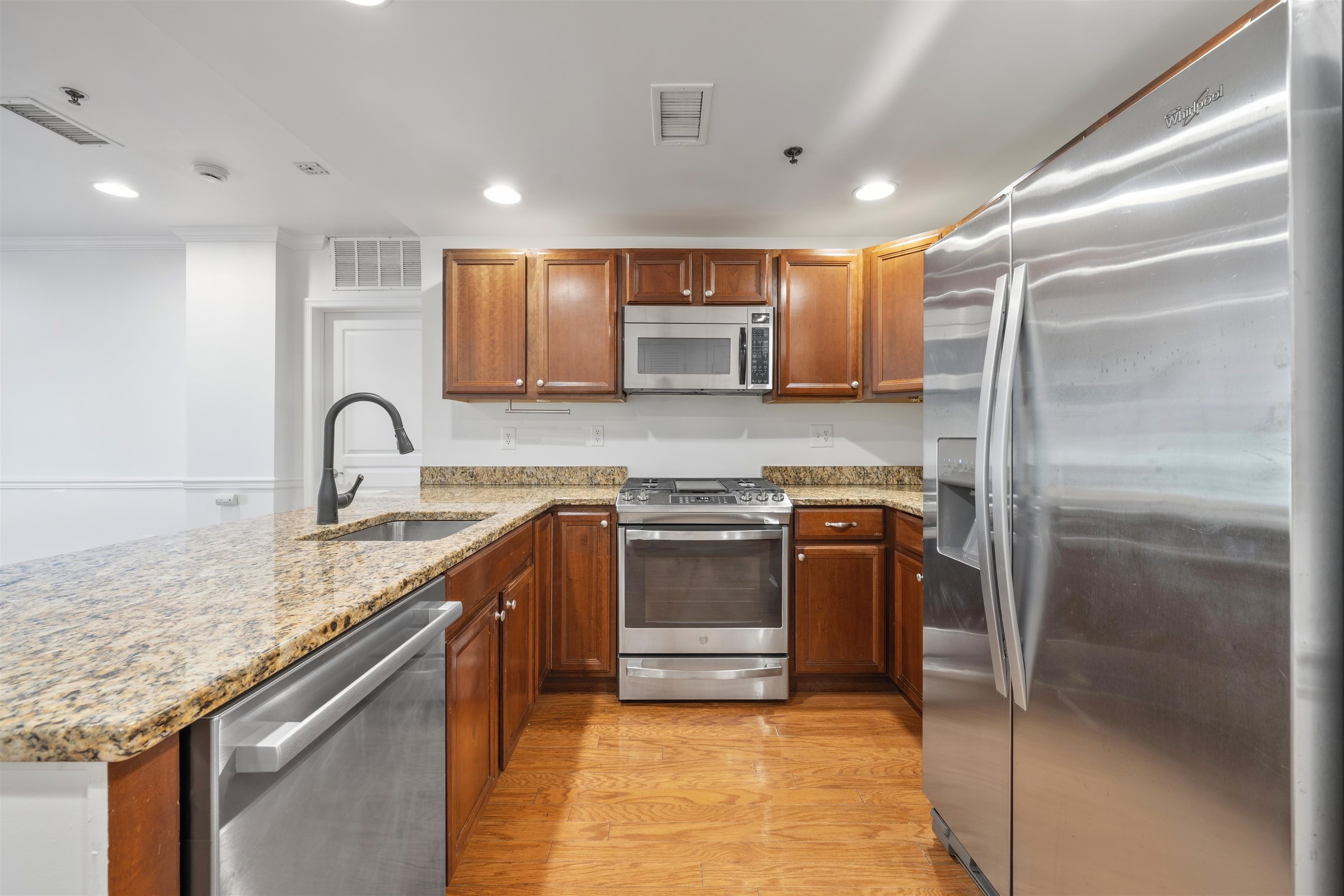 70 Adams Street, Unit 2F Hoboken, NJ 07030 - Photo 3 of 20 a kitchen with stainless steel appliances granite countertop a sink stove and refrigerator