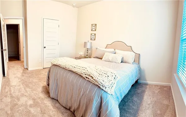 a bedroom with a bed and a mirror