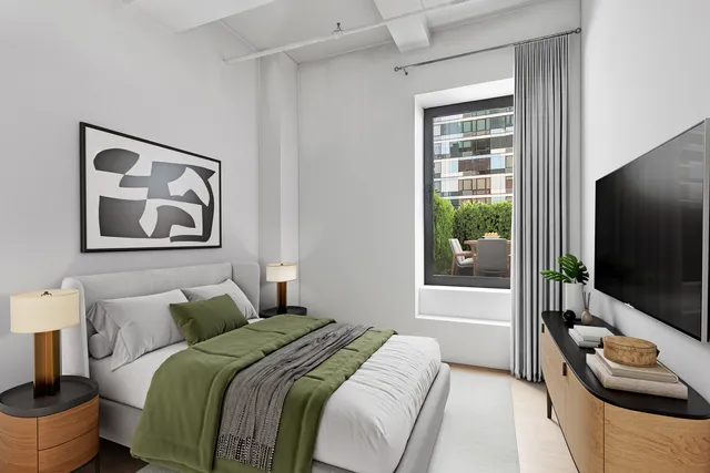 a bedroom with a bed and glass door