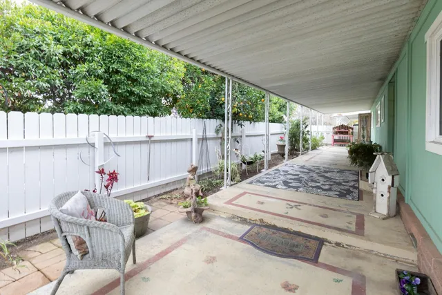 a view of a patio with table and chairs potted plants with wooden floor