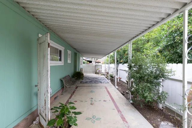 a kitchen with stainless steel appliances a stove a refrigerator and a wooden floor