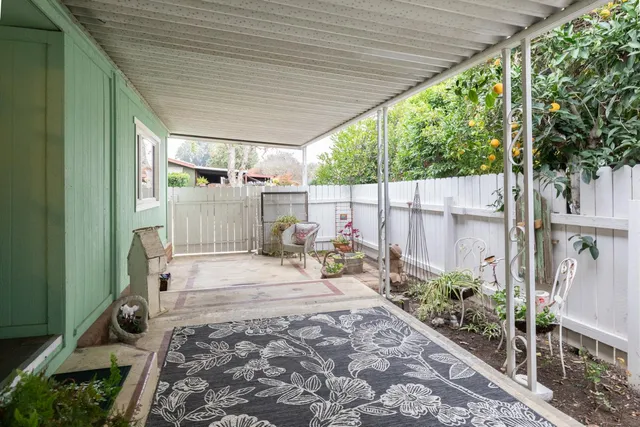 a large white kitchen with cabinets and wooden floor