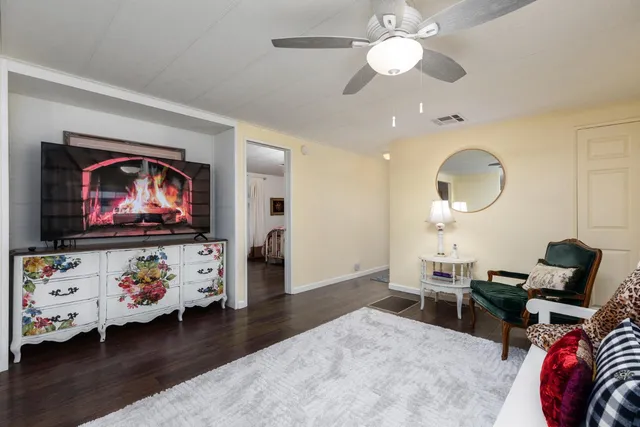 a view of a house with a big yard and large trees