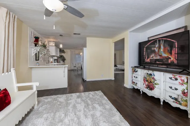 a view of a house with a yard and large tree
