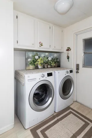 a kitchen with stainless steel appliances a sink cabinets and a window