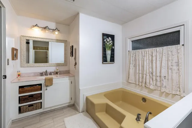 a body of water with a tree in the background