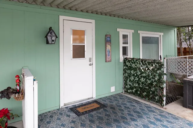 a front view of a house with lots of flowers