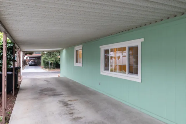 a backyard of a house with outdoor seating and green space