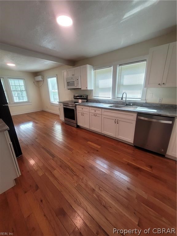 863 Urbanna Road Saluda, VA 23149 - Photo 5 of 24 Kitchen featuring stainless steel appliances, hardwood / wood-style floors, and sink