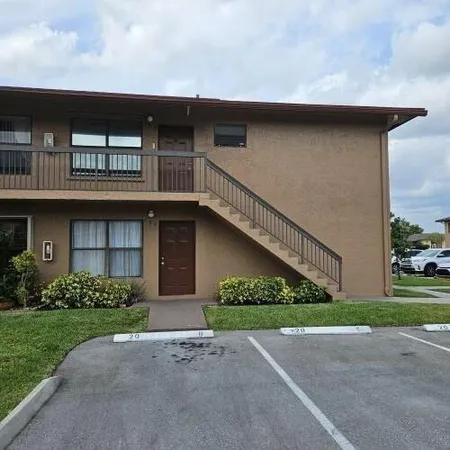 a front view of a house with a garden and plants