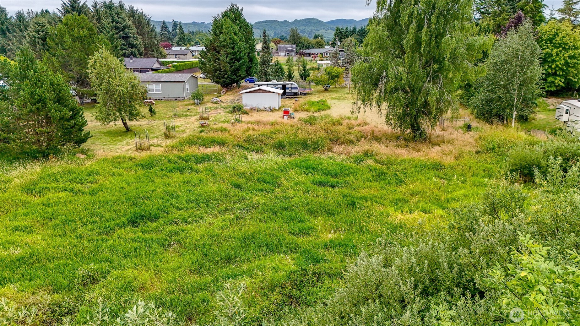 23 Garden Tracts Road Montesano, WA 98563 - Photo 15 of 22 a view of a lake with couches and wooden fence