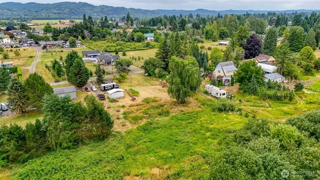 an aerial view of residential house with parking space and city view