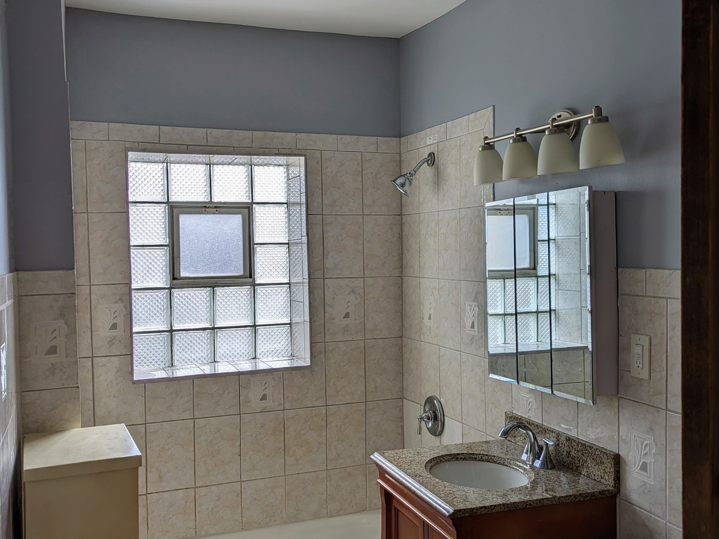 6730 South Ridgeland Avenue, Unit 2 Chicago, IL 60649 - Photo 6 of 12 a bathroom with a sink and a window