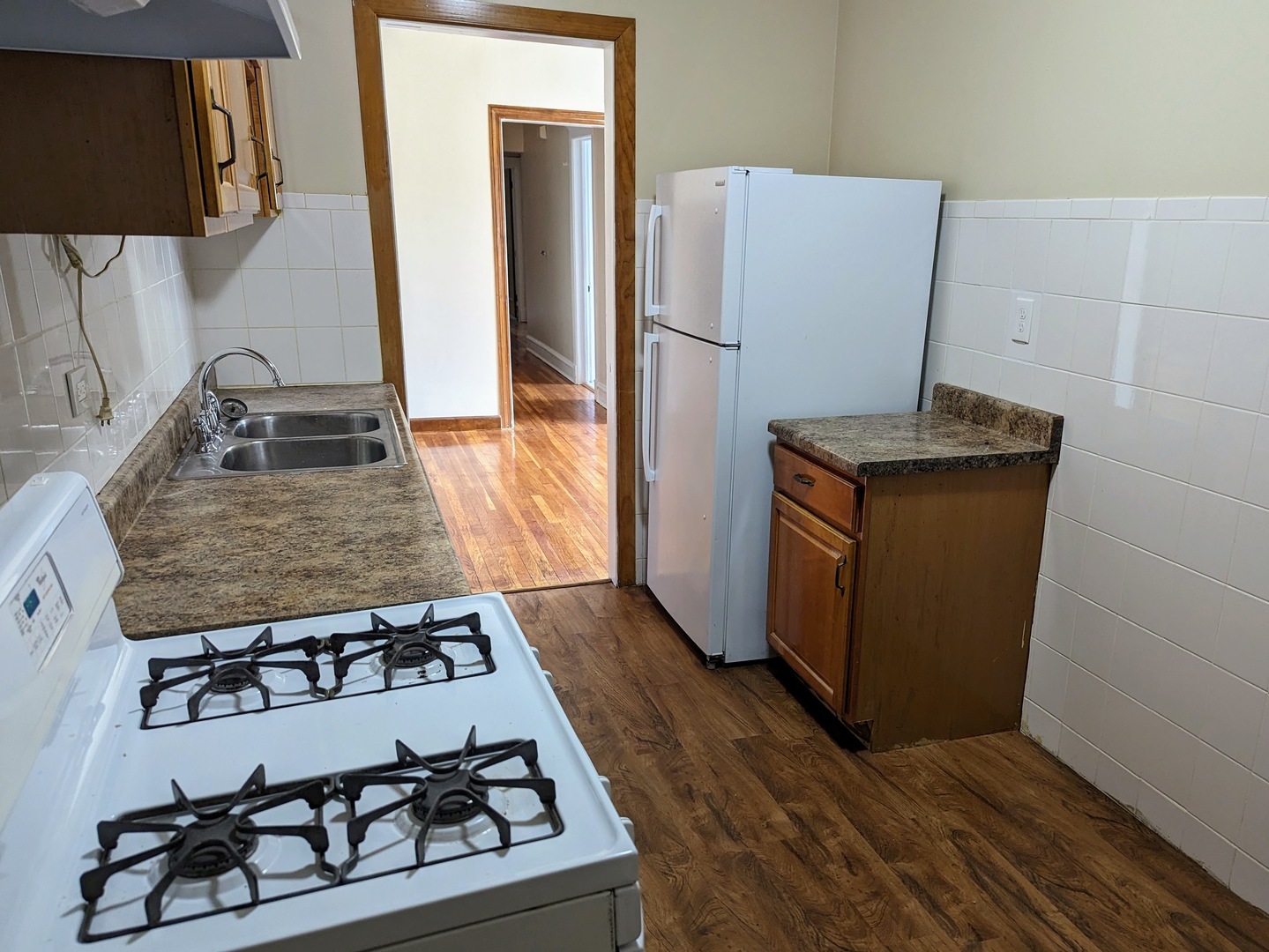 6730 South Ridgeland Avenue, Unit 2 Chicago, IL 60649 - Photo 8 of 12 a kitchen with a stove and a refrigerator