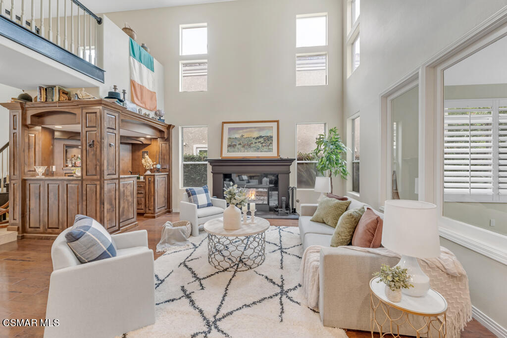 4372 Clearwood Road Moorpark, CA 93021 - Photo 11 of 51 a living room with furniture a fireplace and a large window