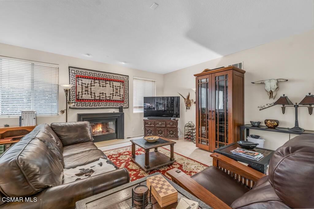 4372 Clearwood Road Moorpark, CA 93021 - Photo 18 of 51 a living room with furniture a flat screen tv and a fireplace