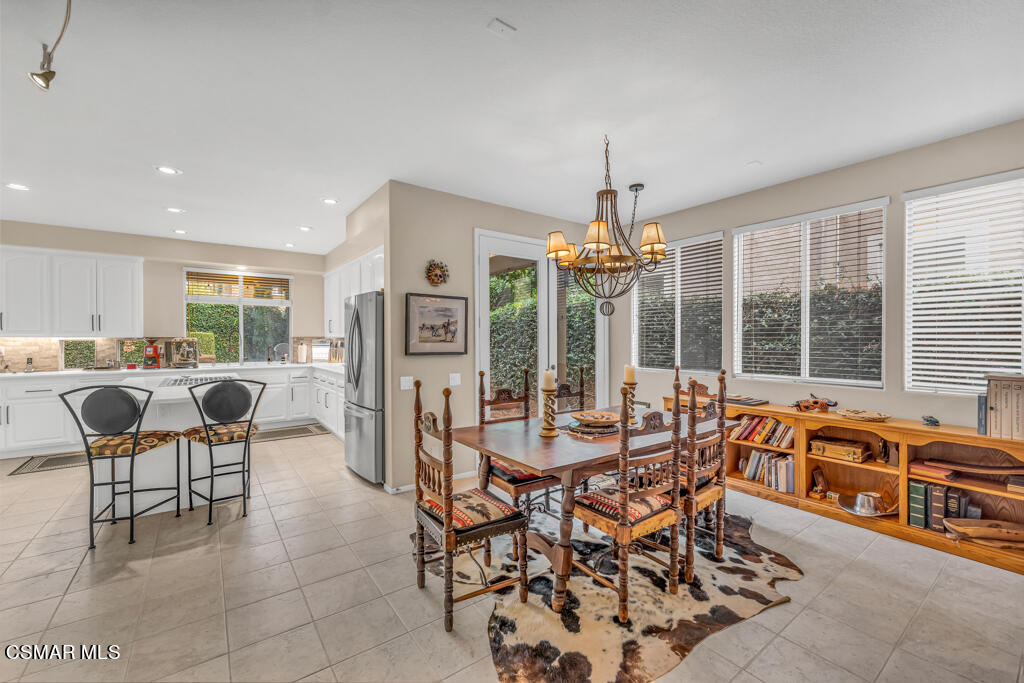 4372 Clearwood Road Moorpark, CA 93021 - Photo 19 of 51 a dining hall with stainless steel appliances kitchen island granite countertop a table and chairs