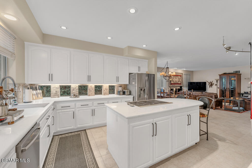 4372 Clearwood Road Moorpark, CA 93021 - Photo 22 of 51 a kitchen with a sink a stove a refrigerator and white cabinets
